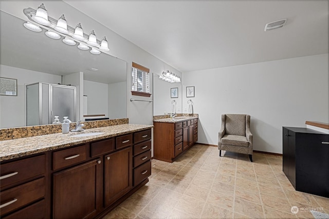 bathroom featuring vanity and an enclosed shower