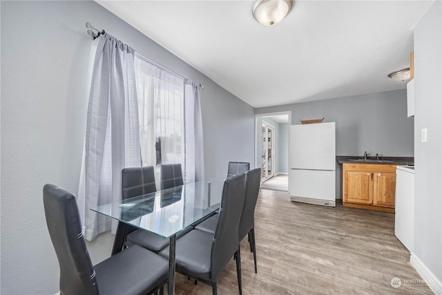 dining area featuring hardwood / wood-style floors and sink