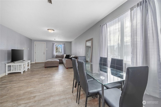 dining space featuring light hardwood / wood-style floors