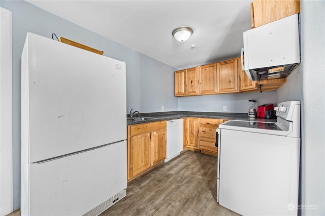 kitchen featuring white appliances, dark hardwood / wood-style floors, and sink