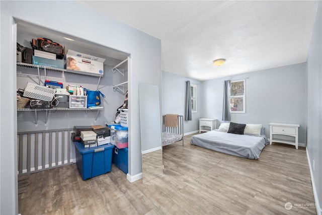 bedroom with hardwood / wood-style flooring