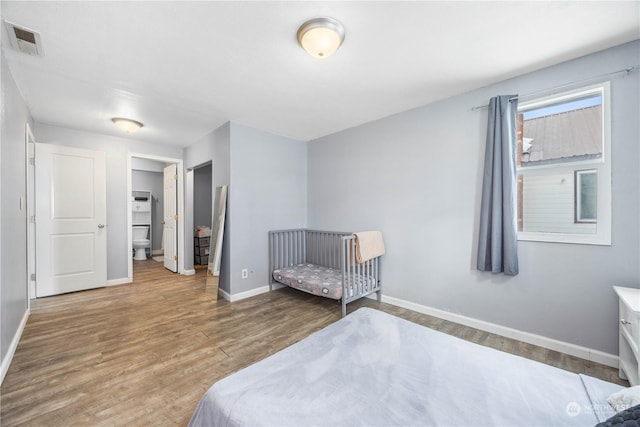 bedroom with hardwood / wood-style floors