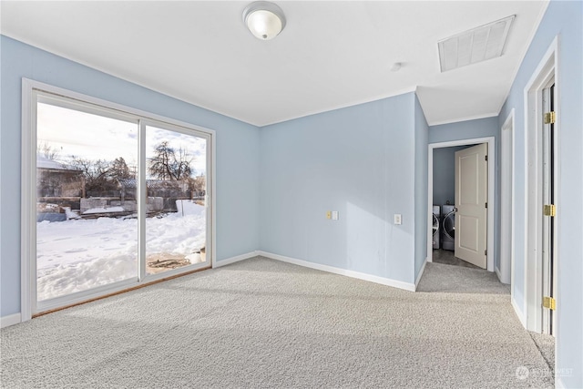 carpeted empty room with independent washer and dryer