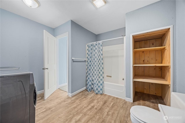 bathroom with shower / tub combo with curtain, toilet, and hardwood / wood-style floors