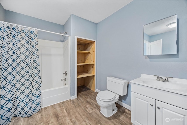 full bathroom with hardwood / wood-style flooring, shower / tub combo with curtain, vanity, and toilet