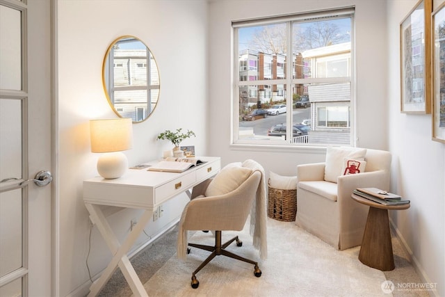 home office with light colored carpet and baseboards