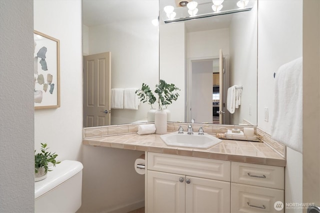 bathroom with toilet and vanity