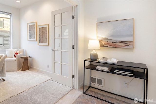 carpeted office space featuring tile patterned floors, visible vents, baseboards, and recessed lighting