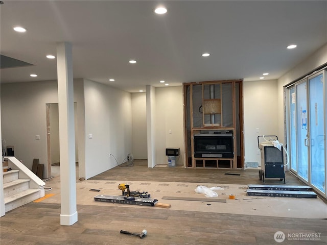 living room with wood finished floors, stairway, and recessed lighting