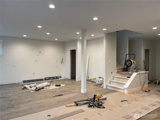 below grade area featuring recessed lighting, stairway, and wood finished floors