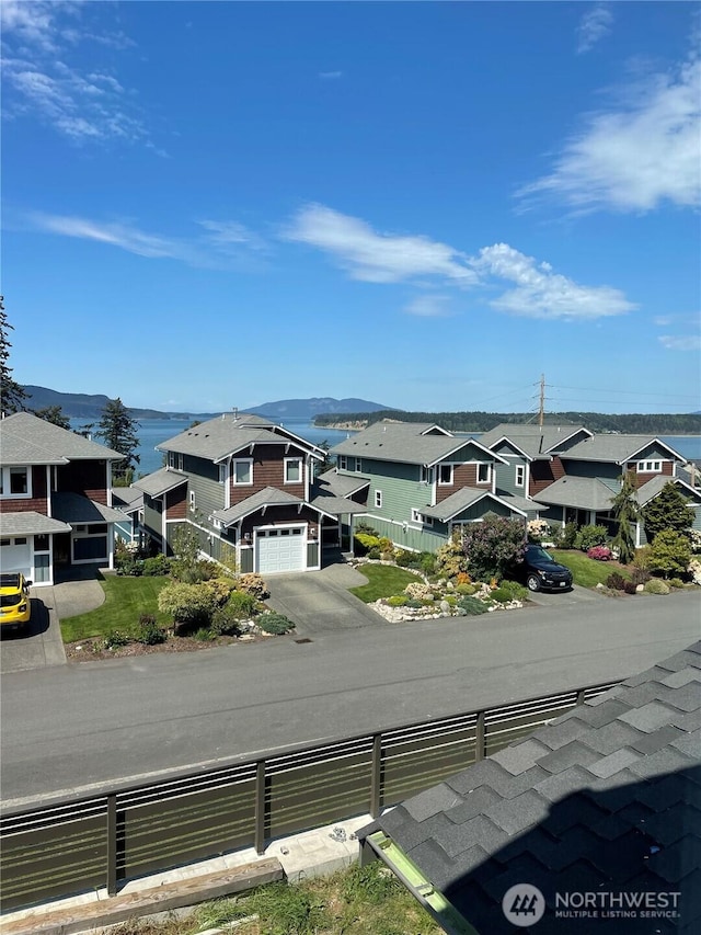 view of asphalt road featuring a residential view
