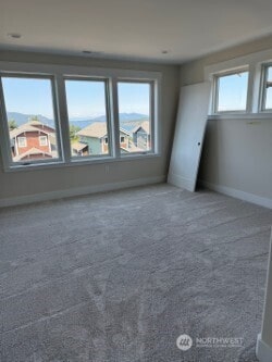 3910 W 3rd St, Anacortes, WA 98221 - unfurnished bedroom with baseboards and carpet floors