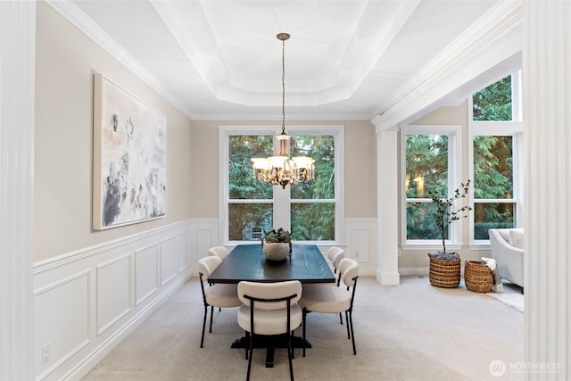 dining room featuring crown molding, light colored carpet, a healthy amount of sunlight, and a chandelier