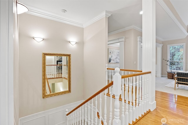 stairway featuring ornamental molding and hardwood / wood-style floors