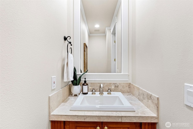 bathroom with vanity and crown molding