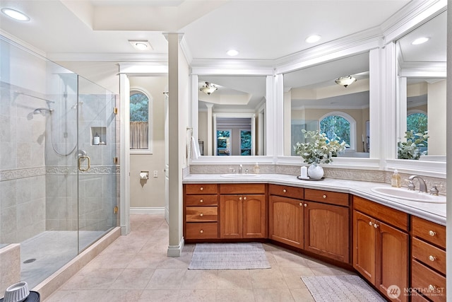 bathroom featuring vanity, tile patterned flooring, ornamental molding, and walk in shower