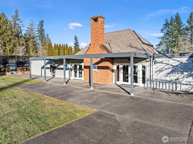 rear view of property featuring french doors and a yard