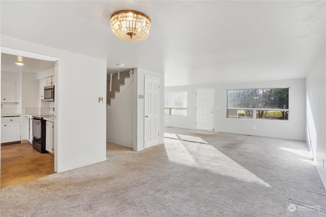 unfurnished living room with light colored carpet