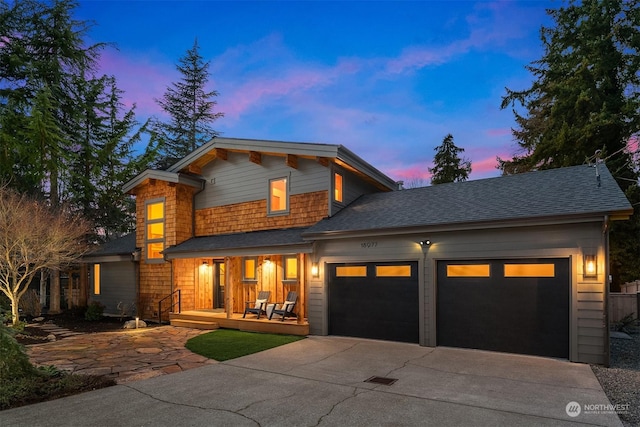 view of front of home with a garage and a porch