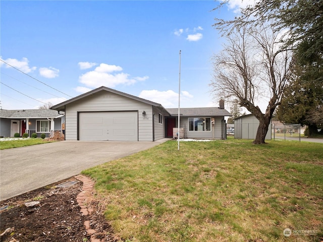 single story home featuring a garage and a front lawn