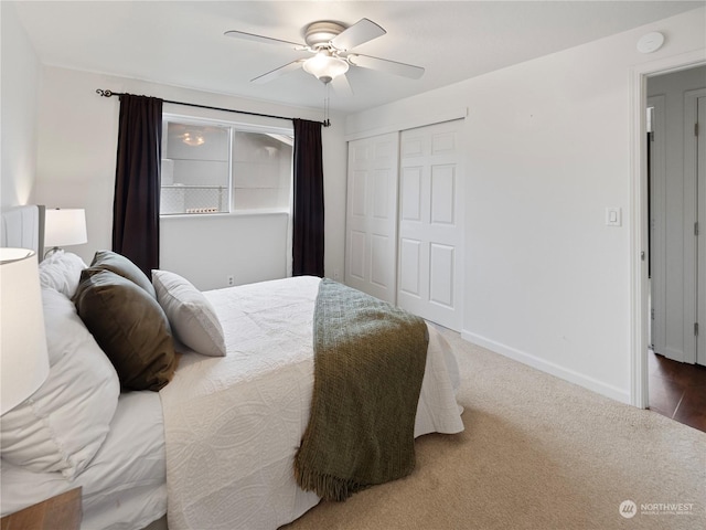 bedroom with ceiling fan, carpet flooring, and a closet