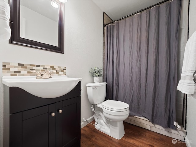 bathroom featuring toilet, tasteful backsplash, a shower with curtain, vanity, and hardwood / wood-style floors