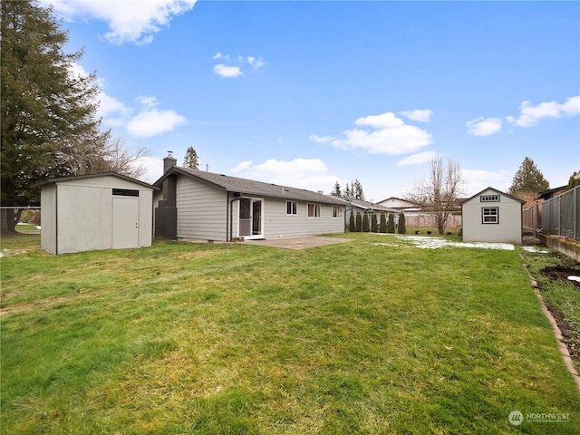 back of property featuring a storage shed, a yard, and a patio area