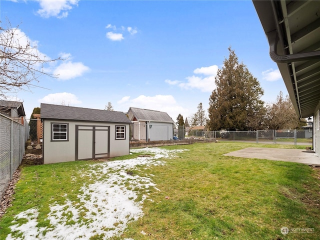 view of yard with a storage shed and a patio area