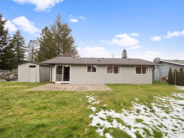 back of property featuring a yard, a patio, and a storage unit