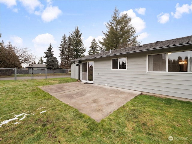 back of property featuring a patio and a lawn