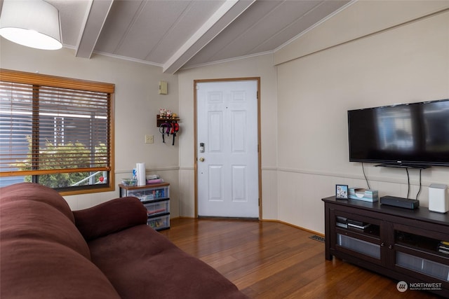 living room with crown molding, vaulted ceiling with beams, and dark hardwood / wood-style flooring