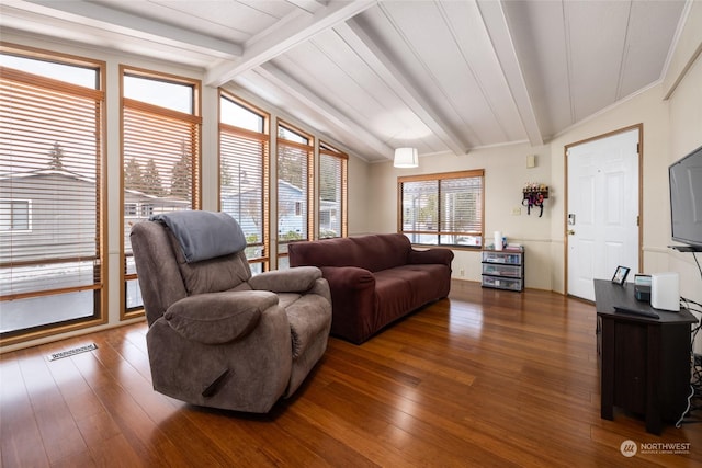 living room with dark hardwood / wood-style flooring and lofted ceiling with beams