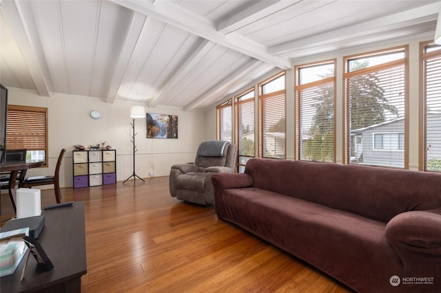 living room with vaulted ceiling with beams and wood-type flooring