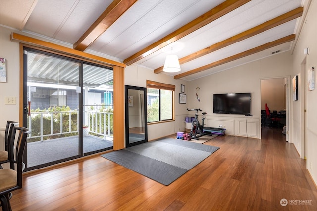 exercise room featuring lofted ceiling and wood-type flooring