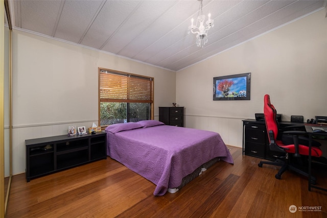 bedroom with crown molding, hardwood / wood-style floors, a notable chandelier, and vaulted ceiling