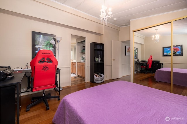 bedroom featuring hardwood / wood-style flooring, crown molding, a closet, and a notable chandelier