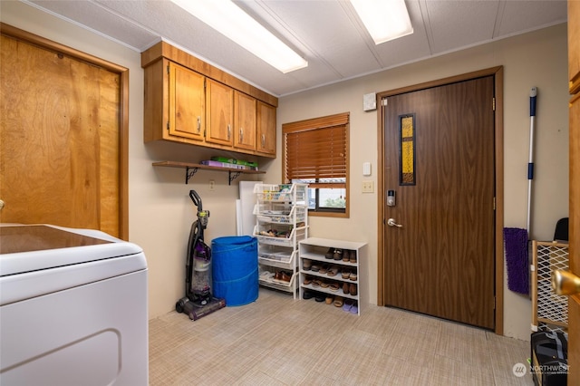 laundry room with cabinets, washer / clothes dryer, and light colored carpet