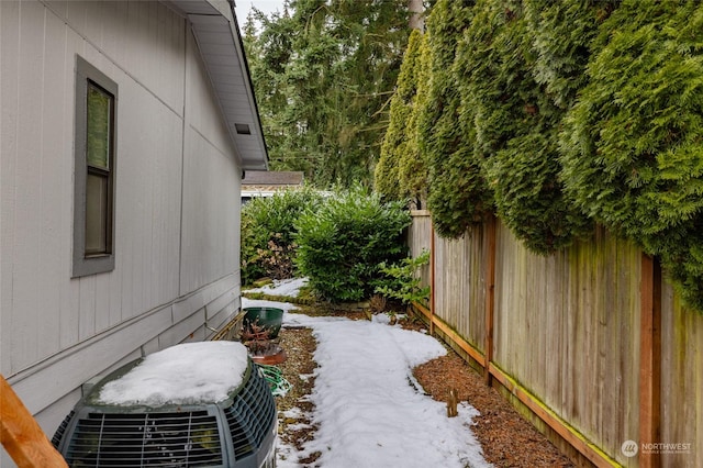 yard layered in snow with central AC