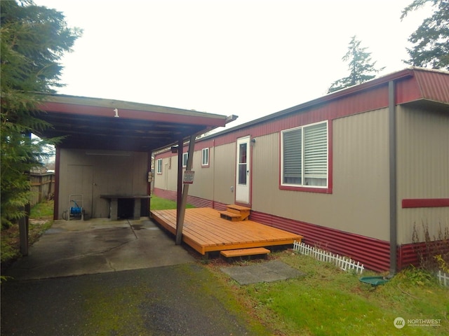 view of home's exterior with a carport and a deck