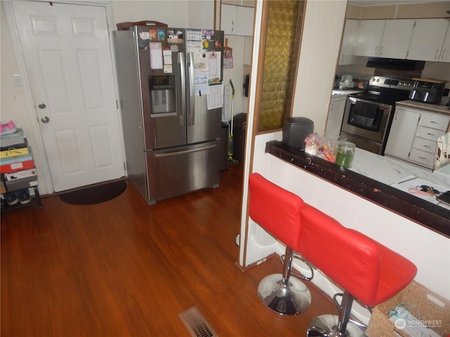 kitchen with dark wood-type flooring and stainless steel appliances