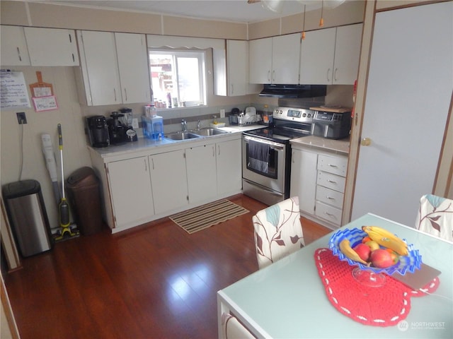 kitchen with dark hardwood / wood-style floors, stainless steel electric stove, sink, and white cabinets