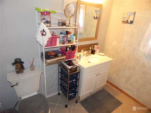 bathroom featuring tile patterned floors, toilet, and vanity
