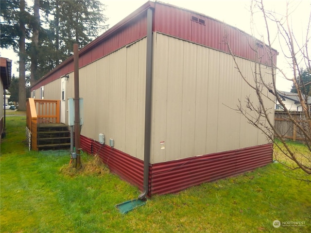 view of side of property with a lawn