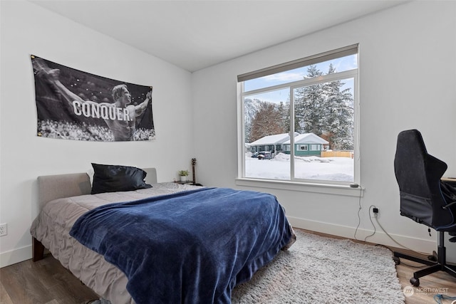 bedroom with hardwood / wood-style flooring