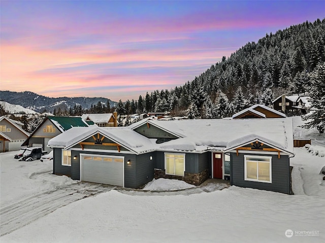 view of front of property with a mountain view and a garage