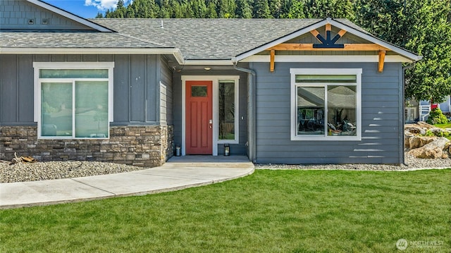 9783 Dye Rd, Leavenworth, WA 98826 - view of front of house with roof with shingles, board and batten siding, stone siding, and a front yard