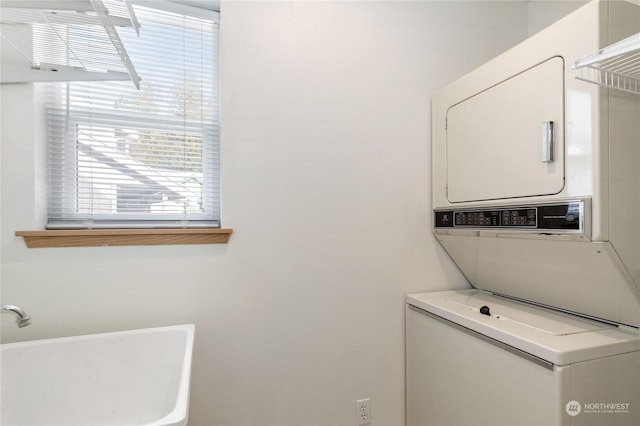 laundry area with stacked washing maching and dryer