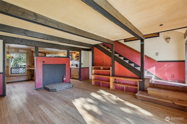 interior space featuring wood-type flooring and beam ceiling