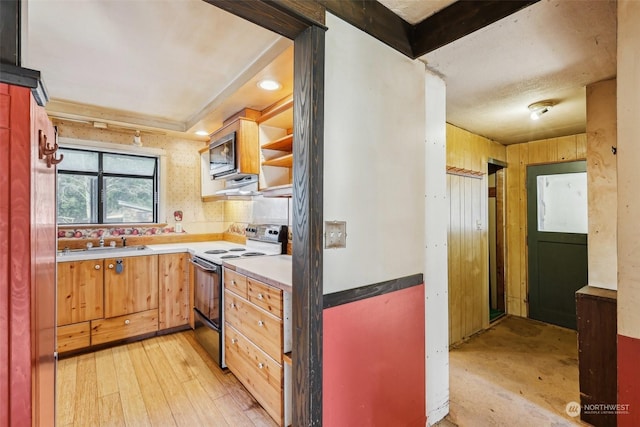 kitchen with electric stove, sink, and light hardwood / wood-style floors