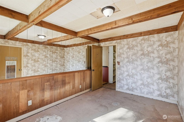 unfurnished room featuring beamed ceiling